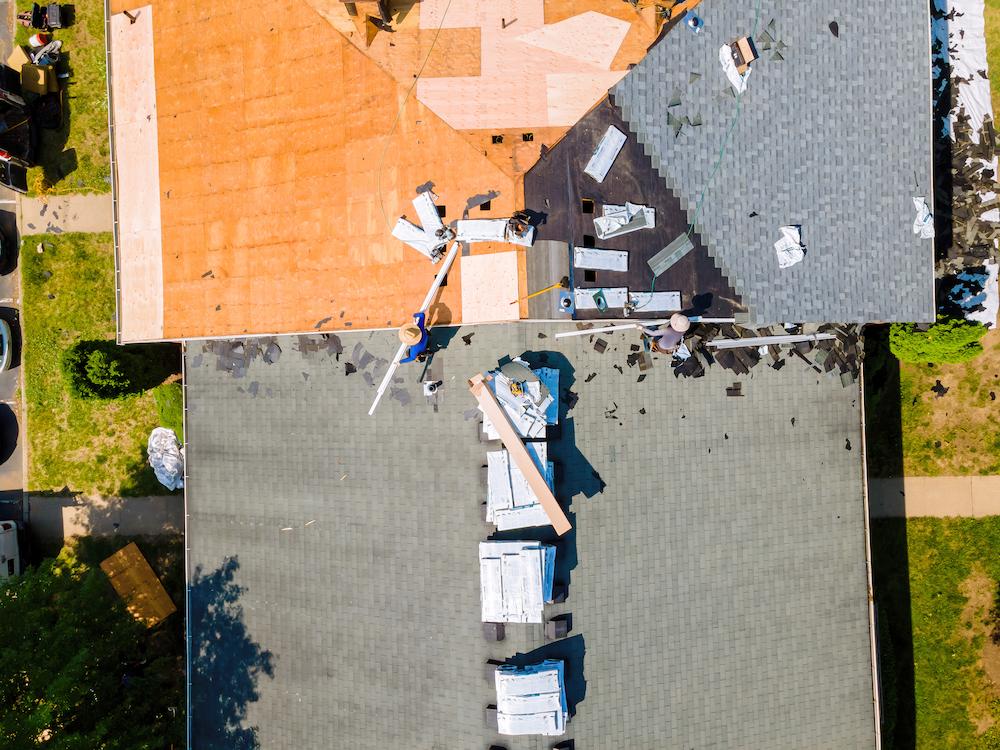 Tackle your Carmel Roof Repair with help from experts at Beard Roofing image shows people working on rooftop