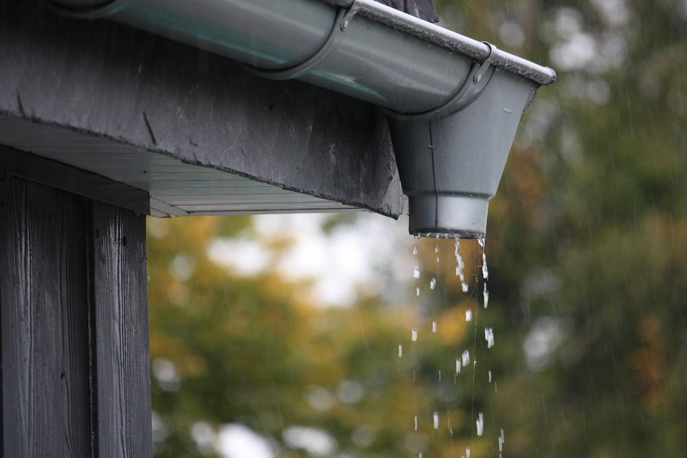 Protect your home by fixing Fishers Gutters problems with help from Beard Roofing image shows water drops falling from gutter
