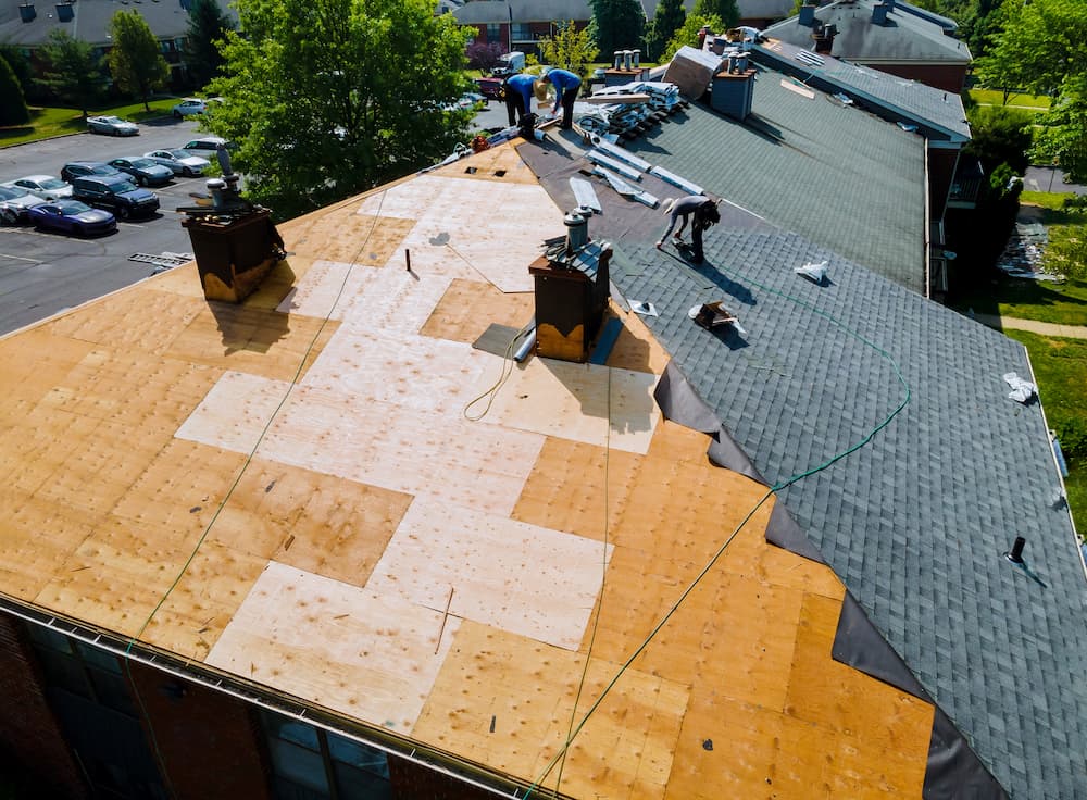 Tackle Indianapolis Storm Damage issues with help from Beard Roofing image shows workers on roof