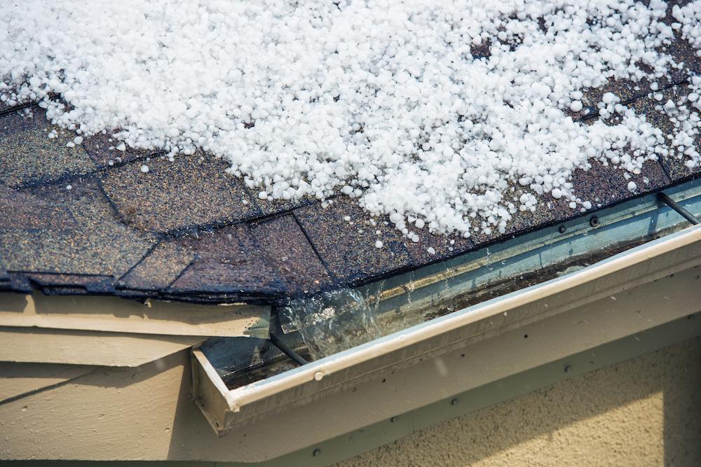 Recover from Westfield Hail Damage with support from Beard Roofing & Exteriors image shows pile of hail on rooftop