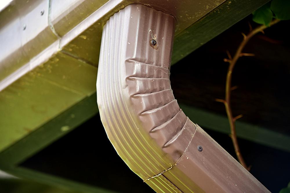 Contact Beard Roofing and Exteriors for Gutters Indianapolis homeowners can rely on image shows gutter spout next to building