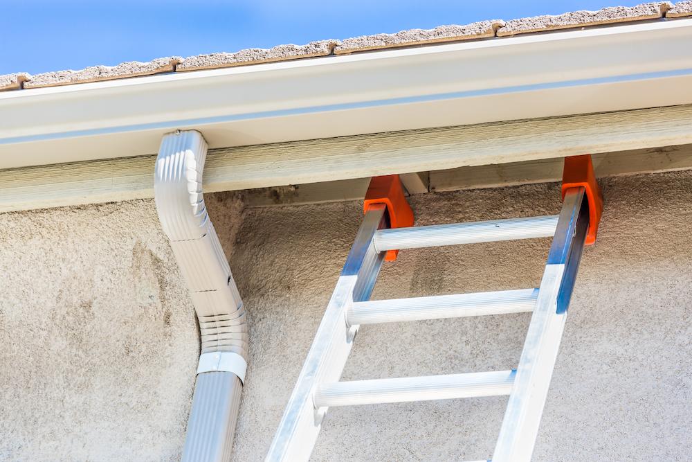 Contact Beard Roofing and Exteriors for professional Indianapolis Gutter Installation image shows ladder next to gutter